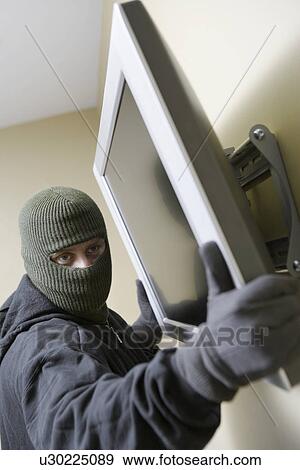 Stock Photo - Thief stealing flat screen television. Fotosearch