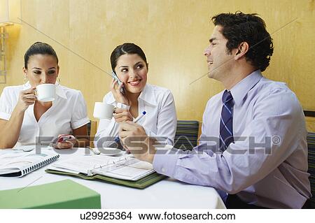 Picture - Three business colleagues in office meeting. Fotosearch