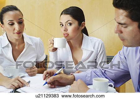 Stock Image - Three business colleagues in office meeting. Fotosearch