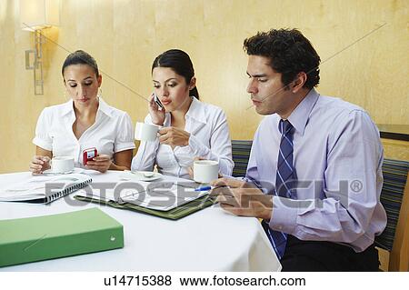 Stock Photo - Three business colleagues in office meeting. Fotosearch