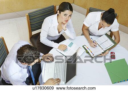 Stock Photo - Three business colleagues working in office. Fotosearch