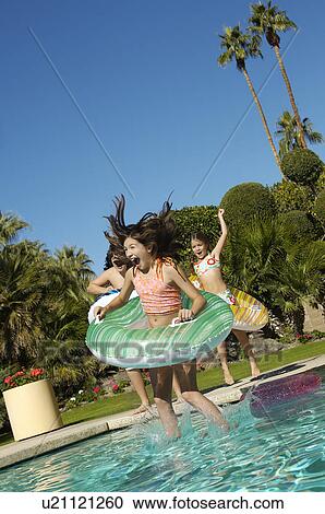 Three children in inflatable rafts jumping into swimming pool View Large Photo Image Stock Image - Three children in inflatable rafts jumping into swimming pool. Fotosearch
