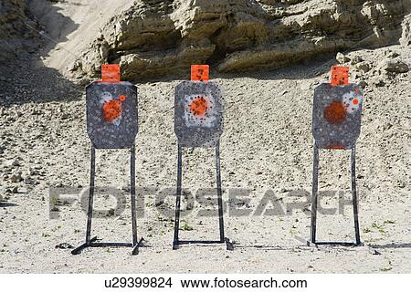 Three targets with bullet holes at firing range View Large Photo Image Picture - Three targets with bullet holes at firing range. Fotosearch