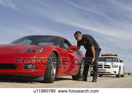 Traffic cop talking with driver of red sports car View Large Photo Image Stock Photo - Traffic cop talking with driver of red sports car. Fotosearch