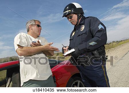 Stock Photography - Traffic cop talking with driver of sports car. Fotosearch