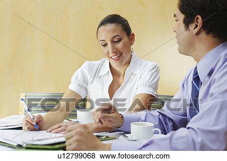 Stock Photo - Two business colleagues in office meeting. Fotosearch