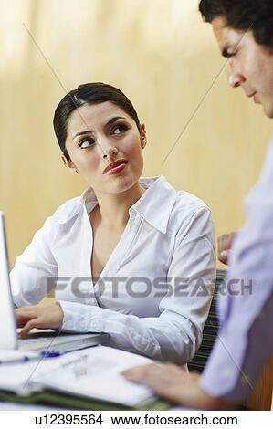Two business colleagues working in office View Large Photo Image Picture - Two business colleagues working in office. Fotosearch