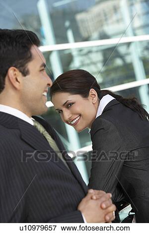 Stock Photo - Two business people outside office. Fotosearch