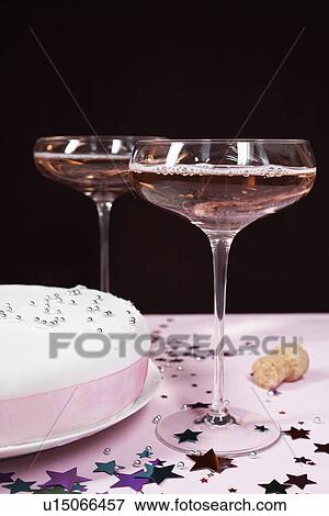 Two champagne glasses and cake, close up View Large Photo Image Stock Photo - Two champagne glasses and cake, close up. Fotosearch