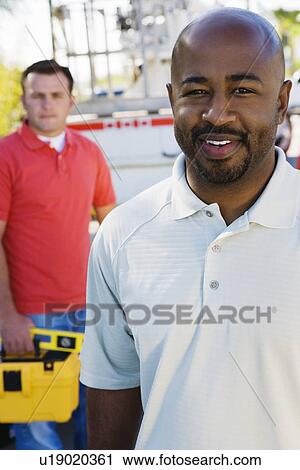 Two construction workers at work View Large Photo Image Stock Image - Two construction workers at work. Fotosearch