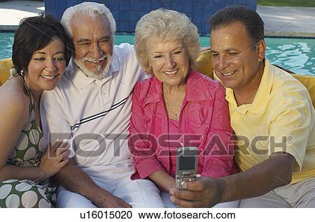 Two couples taking self portrait with mobile phone View Large Photo Image Stock Image - Two couples taking self portrait with mobile phone. Fotosearch