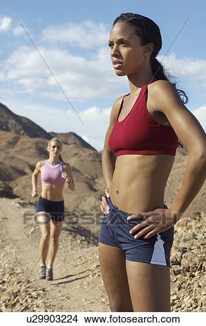 Picture - Two female joggers in mountains. Fotosearch