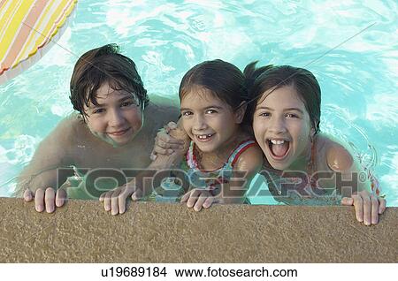 Picture - Two girls and boy in swimming pool, portrait. Fotosearch