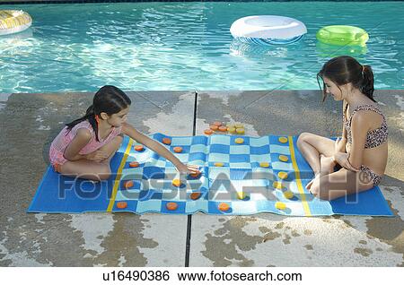 Two girls playing on large draughts board beside swimming pool View Large Photo Image Stock Photograph - Two girls playing on large draughts board beside swimming pool. Fotosearch