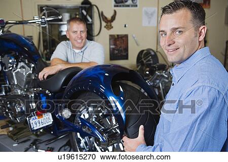 Two mechanics at work View Large Photo Image Stock Image - Two mechanics at work. Fotosearch