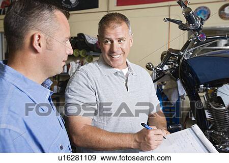 Two mechanics at work View Large Photo Image Stock Photo - Two mechanics at work. Fotosearch