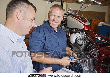 Two mechanics at work View Large Photo Image Stock Photo - Two mechanics at work. Fotosearch
