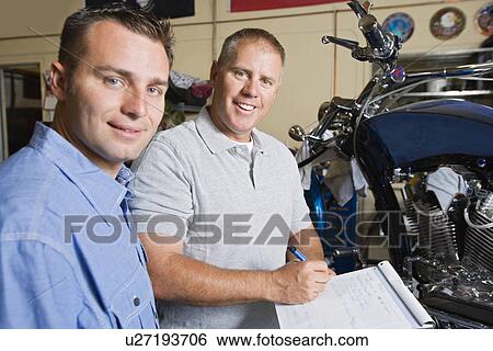Two mechanics at work View Large Photo Image Stock Photograph - Two mechanics at work. Fotosearch