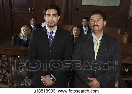 Stock Image - Two men standing in court, portrait. Fotosearch