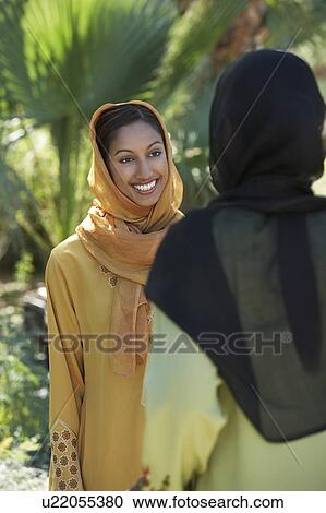 Two muslim woman in traditional clothing talking View Large Photo Image Stock Image - Two muslim woman in traditional clothing talking. Fotosearch