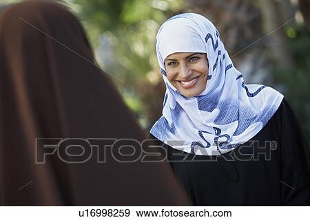 Stock Photo - Two muslim woman talking. Fotosearch
