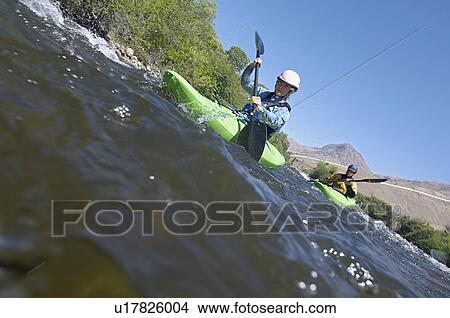 Picture - Two people kayaking in mountain river. Fotosearch