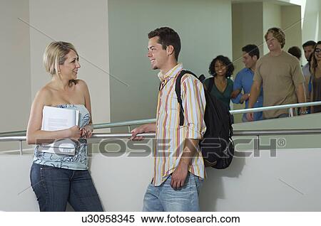 Two students talking on balcony in school View Large Photo Image Stock Photography - Two students talking on balcony in school. Fotosearch