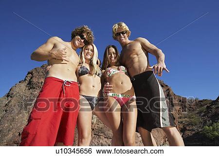 Two young couples embracing by cliff, portrait View Large Photo Image Stock Photograph - Two young couples embracing by cliff, portrait. Fotosearch