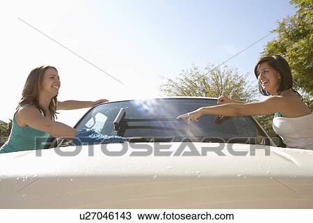 Two young women washing car View Large Photo Image Stock Image - Two young women washing car. Fotosearch