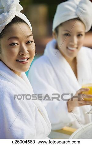 Two young women wearing bathrobes at health spa, portrait View Large Photo Image Stock Image - Two young women wearing bathrobes at health spa, portrait. Fotosearch