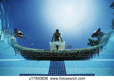 Underwater view of swimmers on diving boards View Large Photo Image Stock Photo - Underwater view of swimmers on diving boards. Fotosearch