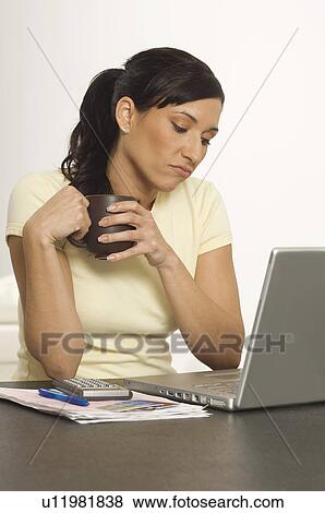 Unhappy Woman Using a Laptop View Large Photo Image Stock Photo - Unhappy Woman Using a Laptop. Fotosearch