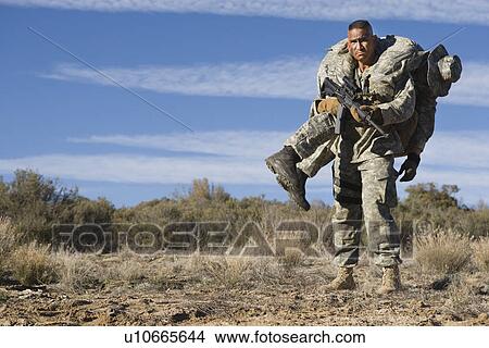 US Army soldier carrying wounded friend View Large Photo Image Picture - US Army soldier carrying wounded friend. Fotosearch