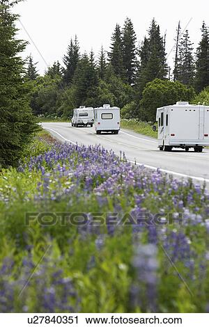 USA, Alaska, row of recreational vehicles on road View Large Photo Image Stock Image - USA, Alaska, row of recreational vehicles on road. Fotosearch