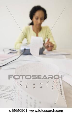 Stock Image - Woman Doing Finances. Fotosearch
