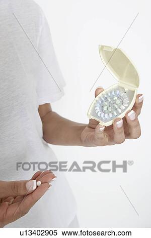 Woman holding pills, close-up View Large Photo Image Stock Photography - Woman holding pills, close-up. Fotosearch