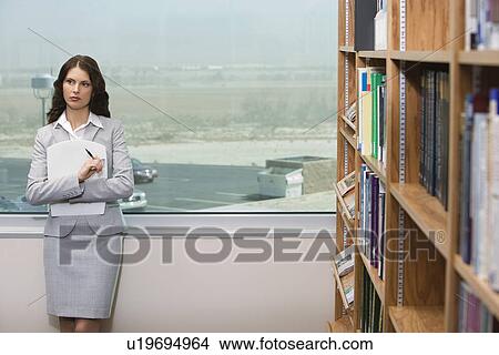 Picture - Woman in library. Fotosearch