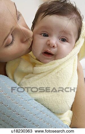 Woman kissing baby (1-6 months), close-up View Large Photo Image Stock Image - Woman kissing baby (1-6 months), close-up. Fotosearch