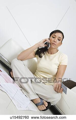 Stock Image - Woman Paying Taxes on Cell Phone. Fotosearch