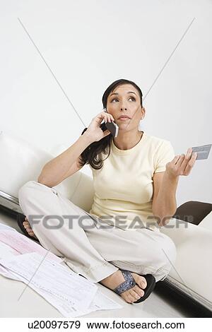 Stock Photo - Woman Placing Order on Cell Phone. Fotosearch