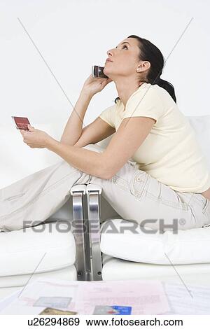 Woman Placing Order on Cell Phone View Large Photo Image Stock Photo - Woman Placing Order on Cell Phone. Fotosearch
