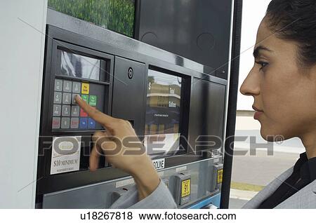 Woman pushing buttons on gas pump View Large Photo Image Stock Photo - Woman pushing buttons on gas pump. Fotosearch