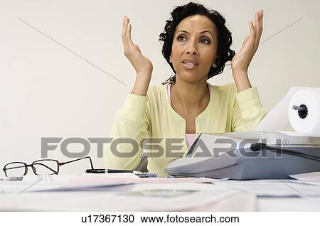 Stock Image - Woman Upset over Bills. Fotosearch