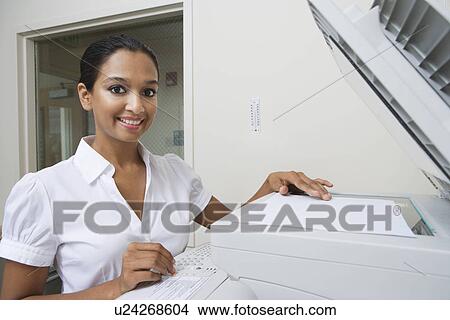 Picture - Woman Using Photocopier. Fotosearch