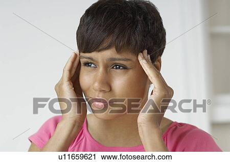 Woman with hands on temples, indoors View Large Photo Image Stock Image - Woman with hands on temples, indoors. Fotosearch
