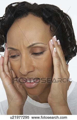 Stock Photography - Woman with head in hands, close-up. Fotosearch