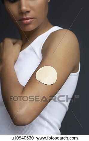 Woman with patch on arm, close-up, studio shot View Large Photo Image Stock Image - Woman with patch on arm, close-up, studio shot. Fotosearch