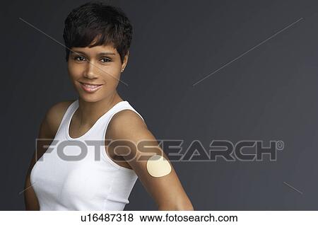 Stock Photo - Woman with patch on arm, portrait. Fotosearch