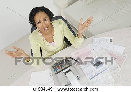 Stock Image - Woman Worried About Finances. Fotosearch