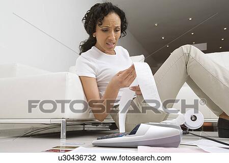 Stock Image - Woman Worried About Finances. Fotosearch